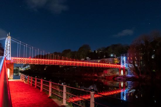 Shakey bridge lit up in red