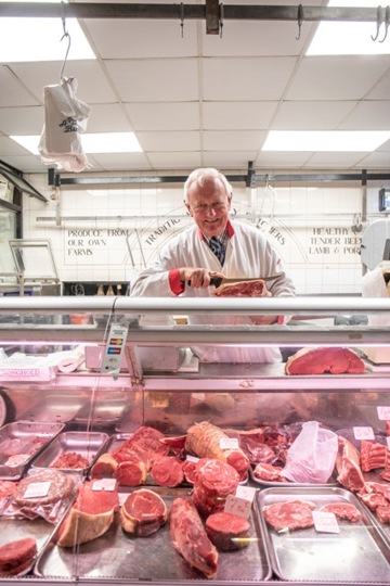 Employee posing at chicken display