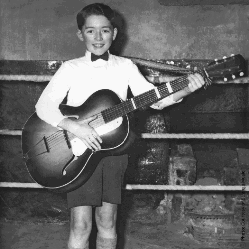 A young Rory with his guitar playing at St Augustine's Hall