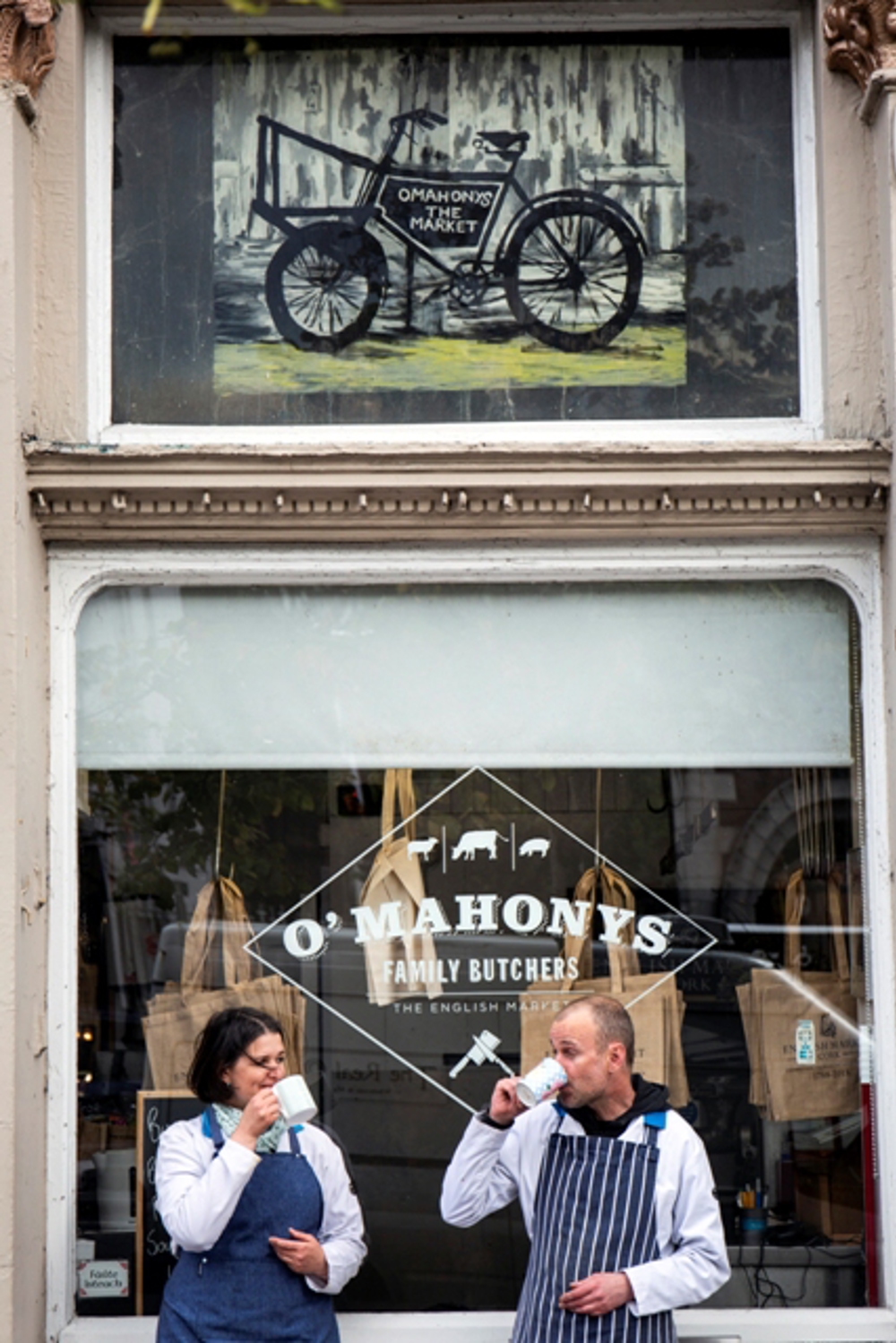 Employees enjoying coffee outside O'Mahonys sign