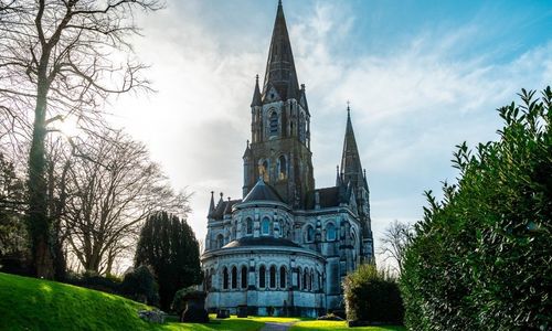The view from the front of St Fin Barre's Cathedral underneath blue skies