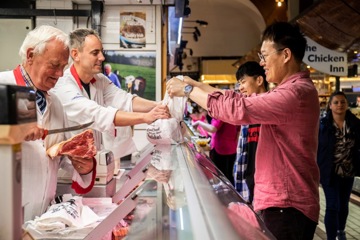 Employee handing purchase to customer