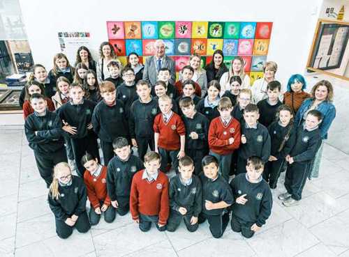 Group of primary school students, teachers, artists and Lord Mayor stand in front of art display