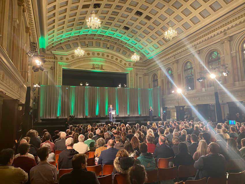Green Party National Convention 2023 Leader's Speech, with Deputy Eamon Ryan on the stage, lit by green light
