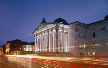 Cork Courthouse at night with traffic lights blurred artistically