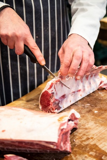 employee preparing ribs