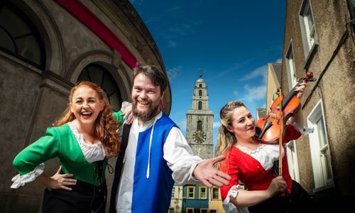 Three people in costume with Shandon in the background